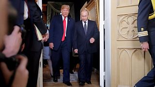 President Donald Trump, left, and Russian President Vladimir Putin, right, arrive for a one-on-one-meeting at the Presidential Palace in Helsinki, Finland, July 16, 2018