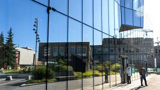 Bank customers exit Lithuania's UAB Urbo Bankas, which was imposed sanctioned by the Chinese Ministry of Commerce on Wednesday, in Vilnius, Lithuania, 