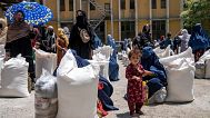 Afghan women receive food rations distributed by a humanitarian aid group in Kabul, 28 May, 2023