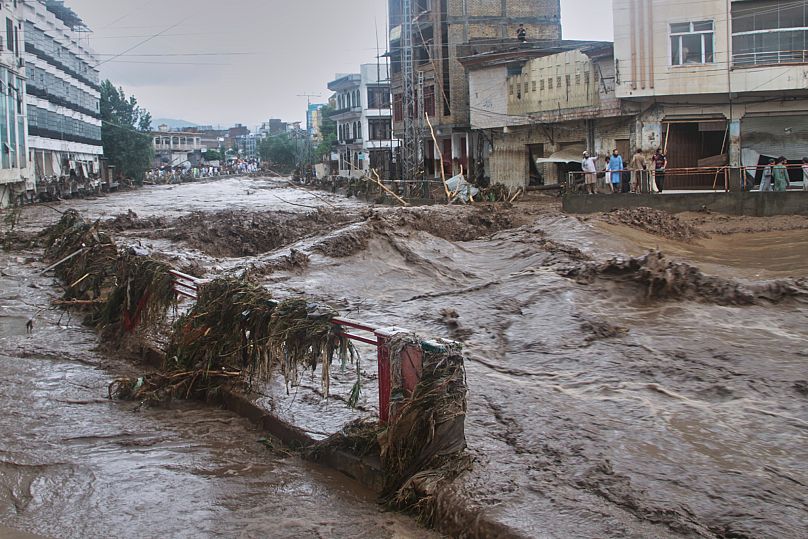 Eesidents look at flash flooding due to heavy rains in Mingora, the main town of Swat Valley, northwestern Pakistan, 15 August 2025