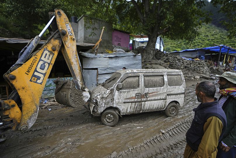 An earth mover clears a road after Thursday's flash floods in Chositi village, Kishtwar district, Indian-controlled Kashmir, 15 August 2025
