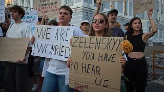 Participants hold signs during a protest against a new bill proposed by President Volodymyr Zelenskyy restoring the independence of the country’s anti-corruption agencies