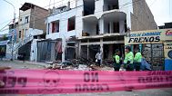 Police stand outside a building damaged by an explosion in Trujillo, 14 August, 2025