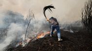 A man battles a wildfire in Veiga das Meas, northwestern Spain, Saturday, Aug. 16, 2025. 