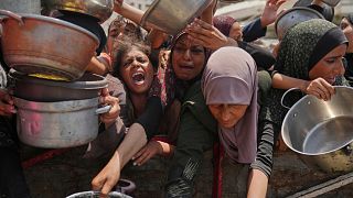 People in Gaza scramble for food aid as the death toll from hunger rises