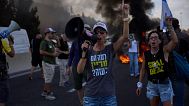 Demonstrators block a road during a protest demanding the immediate release of hostages held by Hamas near Jerusalem, Israel, Sunday, Aug. 17, 2025.