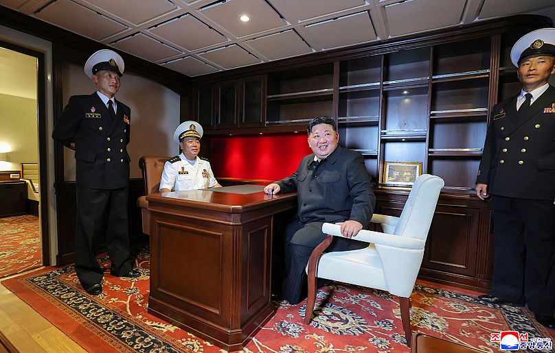 In this photo provided by the North Korean government, North Korean leader Kim Jong Un, center right, inspects the warship Choe Hyon in Nampo, North Korea, on Aug. 18, 2025.