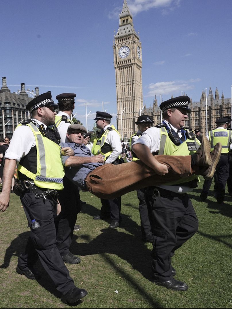 A man is detained by police as supporters of Palestine Action protest in London in August 2025.