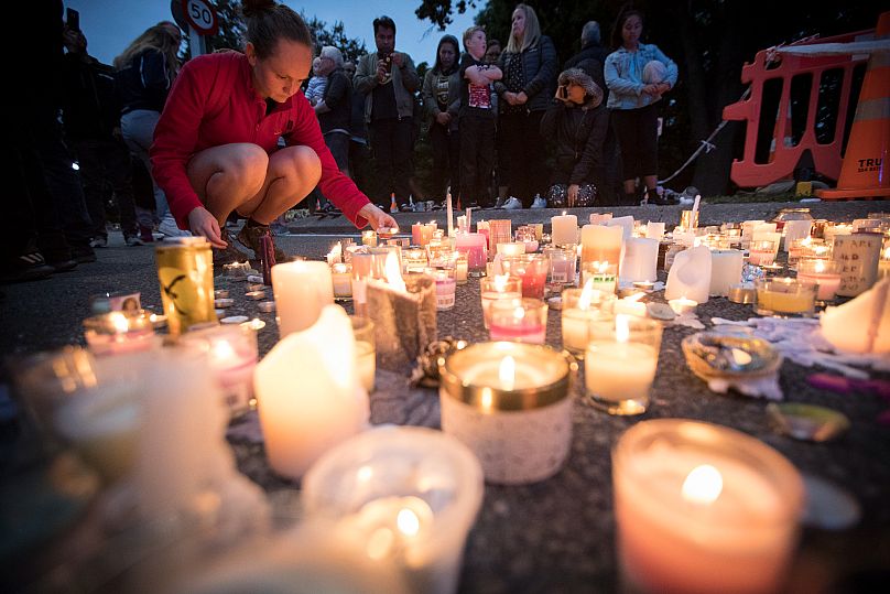 Candles are placed to commemorate victims of the shooting outside the Al Noor mosque in Christchurch, 18 March, 2019