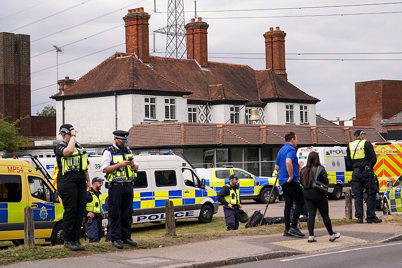 Police officers patrol the Bell Hotel in Epping, near London, Sunday, July 27, 2025.