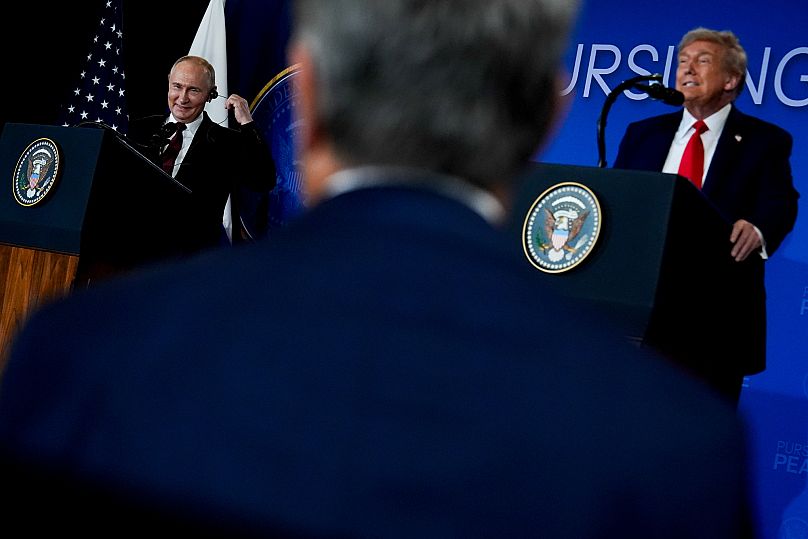 US President Donald Trump listens as Russia's President Vladimir Putin speaks during a news conference in Anchorage, 15 August, 2025