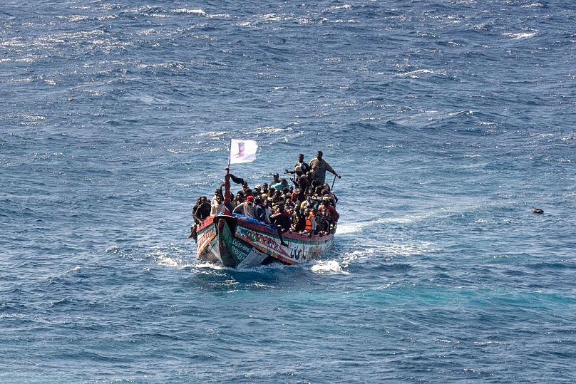 Migrants crowd a wooden boat as they sail to the port in La Restinga on the Canary island of El Hierro, 18 August, 2024