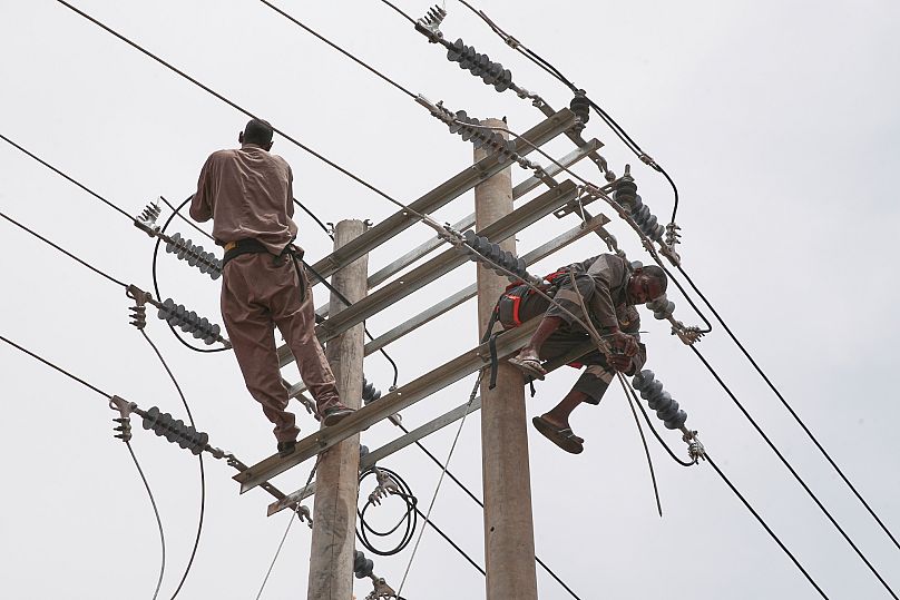 Workers fix electricity cables, destroyed during fighting between the Sudanese Armed Forces and the paramilitary Rapid Support Forces, in Khartoum, Sudan, Aug. 18, 2025