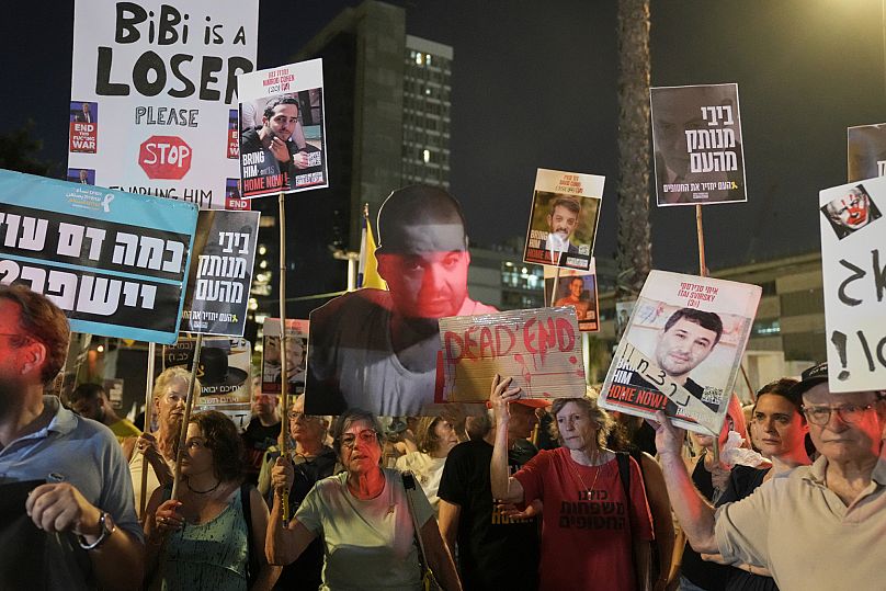 Protesters demanding immediate release of hostages and call for the end of the war in the Gaza Strip, as they march in Tel Aviv, Israel, Thursday, Aug. 21, 2025.
