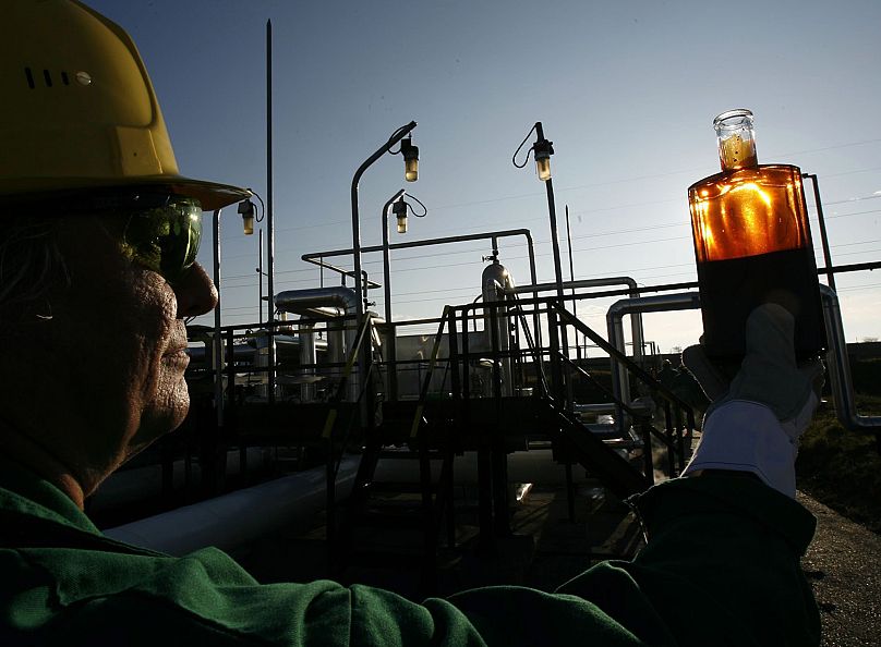 A worker examines a sample at the receiving station of the oil pipeline 'Druzhba south of Budapest, 11 January, 2007 