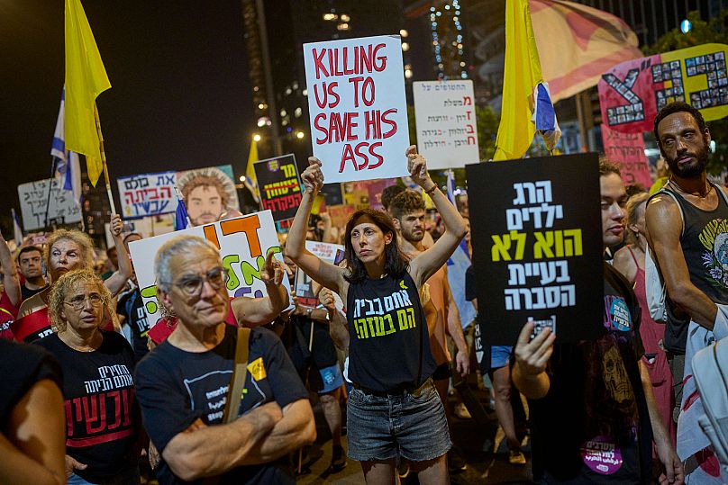 People take part in a protest demanding the end of the war and immediate release of hostages in Tel Aviv, 23 August, 2025