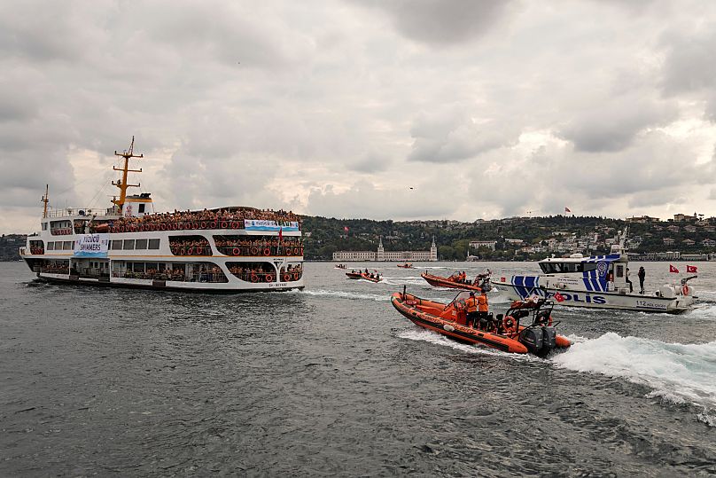 Competitors aboard a ferry heading to the start line of a 6.5-kilometer swimming race across the Bosphorus Strait, 24 August, 2025