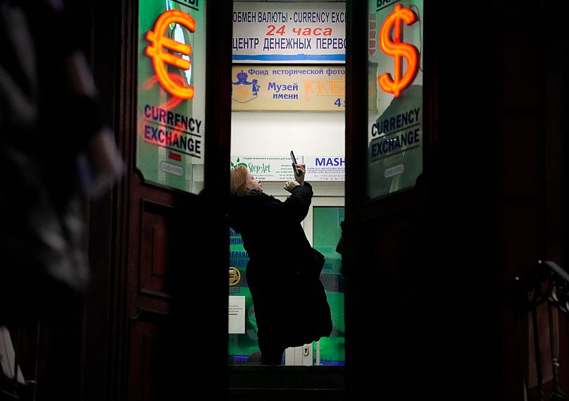A woman stands in a currency exchange office in St. Petersburg, 25 February, 2022