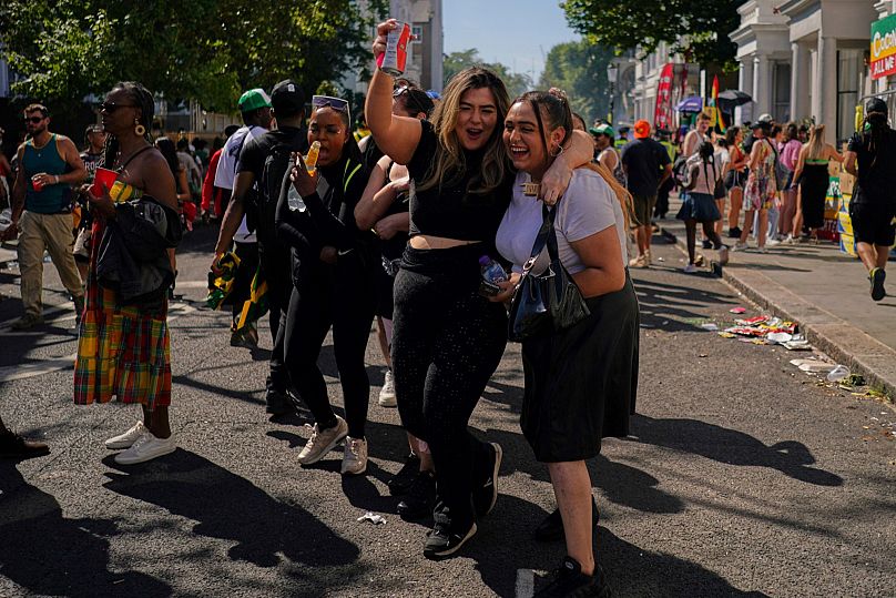 Away from the parade, revellers party through the streets and listen to sound systems 
