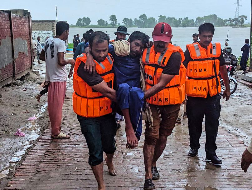 Rescue workers evacuate villagers from a low-lying area due to rising water level in the Sutlej River in Pakistan's Punjab province, 26 August, 2025