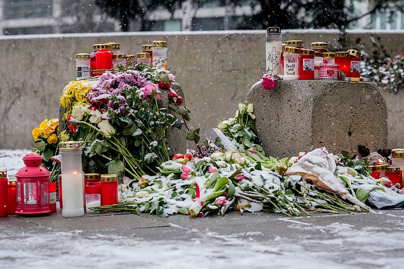 Flowers and candles are laid in Munich near the spot where a car drove into a group of protesters, 16 February, 2025