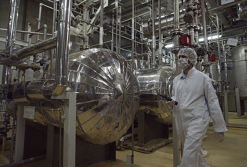 An Iranian security official in protective clothing walks through part of the Uranium Conversion Facility just outside the city of Isfahan, 30 March, 2005