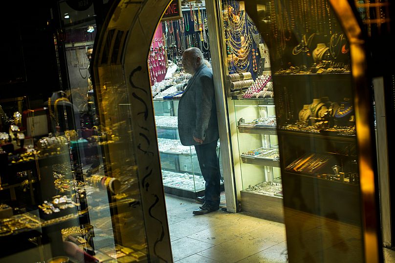 A seller waits for customers in his jewellery shop at the Grand Bazaar in Istanbul, 16 December, 2021