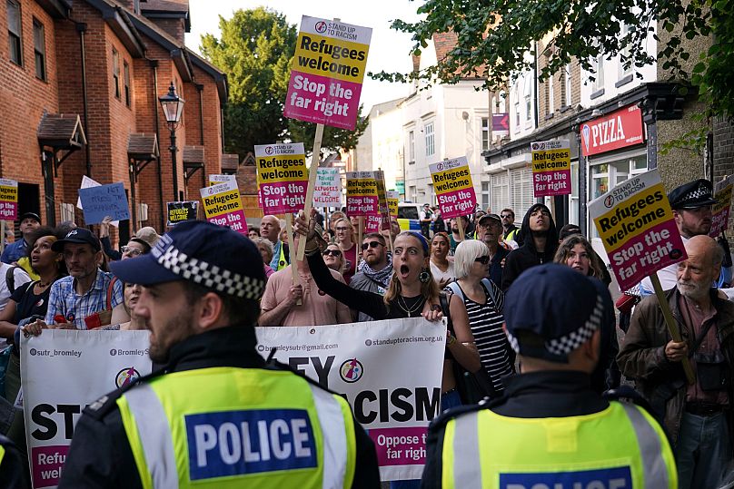 Protesters hold placards during a demonstration in Orpington near London, 22 August, 2025