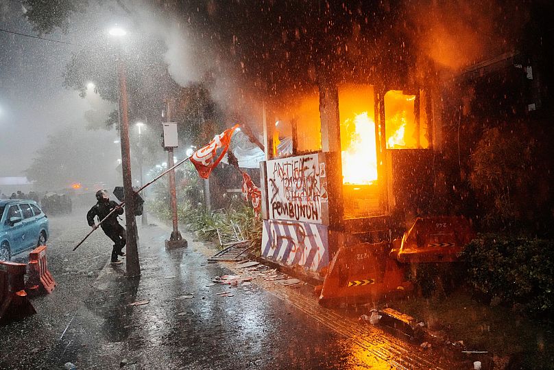 A traffic police post is burned during a protest in Jakarta, 29 August, 2025