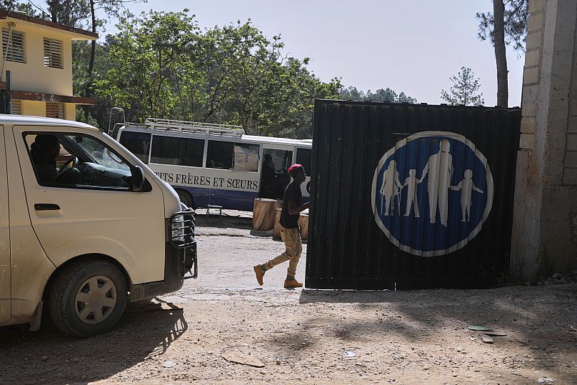 Workers enter the Saint- Hélène orphanage in the Kenscoff neighbourhood of Port-au-Prince, 4 August, 2025
