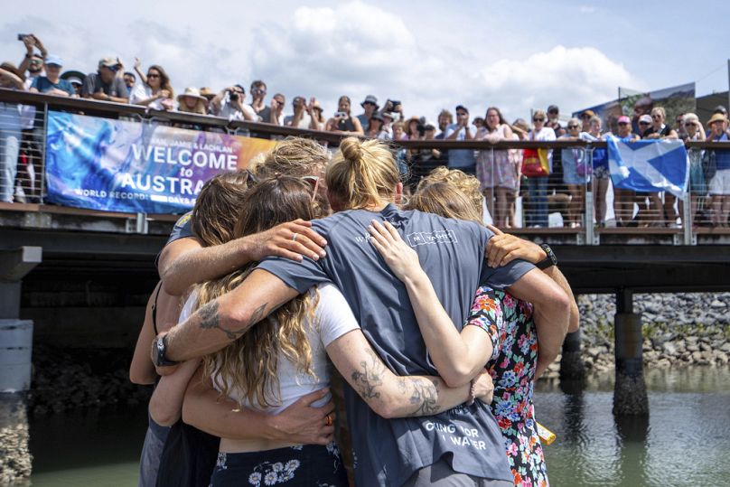 Scottish brothers, Ewan, Jamie and Lachlan, Maclean are embraced by family after completing their record breaking row from Peru across the Pacific Ocean to Cairns, Australia, 