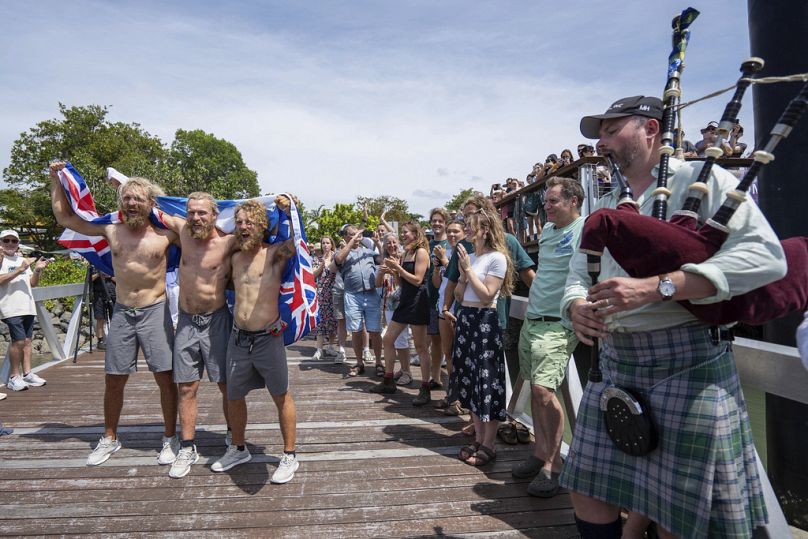 Scottish brothers, Ewan, Jamie and Lachlan, Maclean react after completing their record breaking row from Peru across the Pacific Ocean to Cairns, Australia, Saturday, Aug. 30