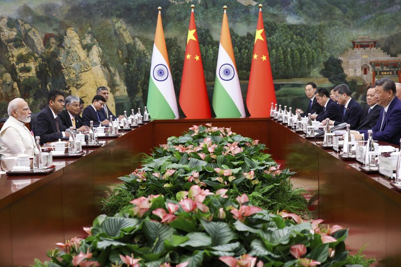 In this photo provided by Indian Prime Minister's Office, Indian Prime Minister Narendra Modi, left, and Chinese President Xi Jinping, right, hold a meeting on the sidelines o