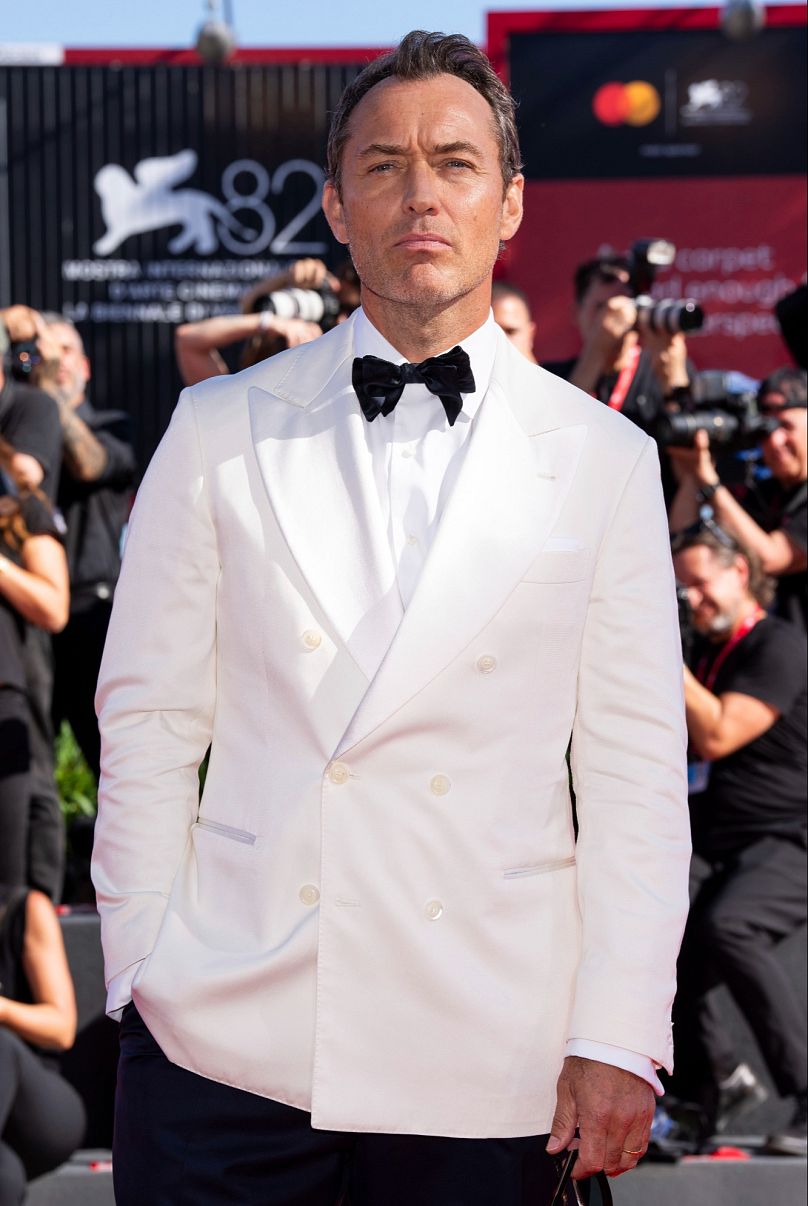 Jude Law cut a dashing and dapping figure in his white tuxedo on the red carpet for 'The Wizard of the Kremlin'