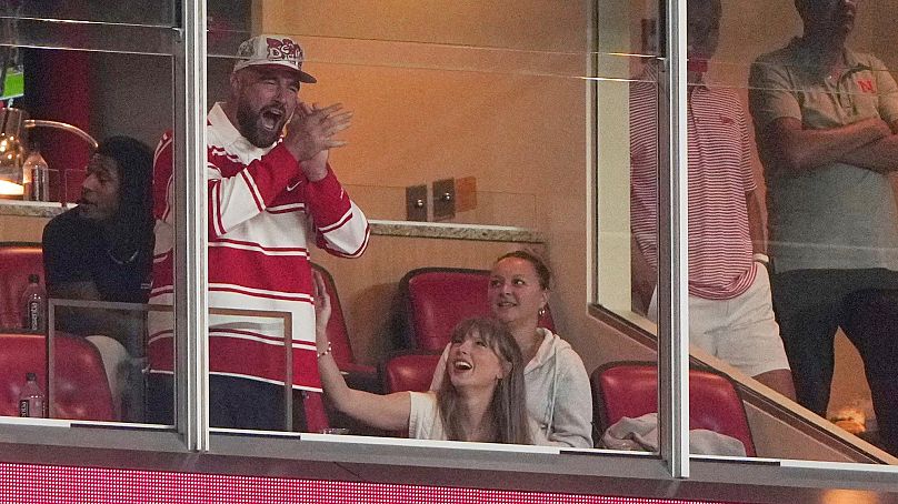 Taylor Swift sits with fiance Travis Kelce as they watch during the second half of an NCAA college football game between Cincinnati and Nebraska - 28 August 2025