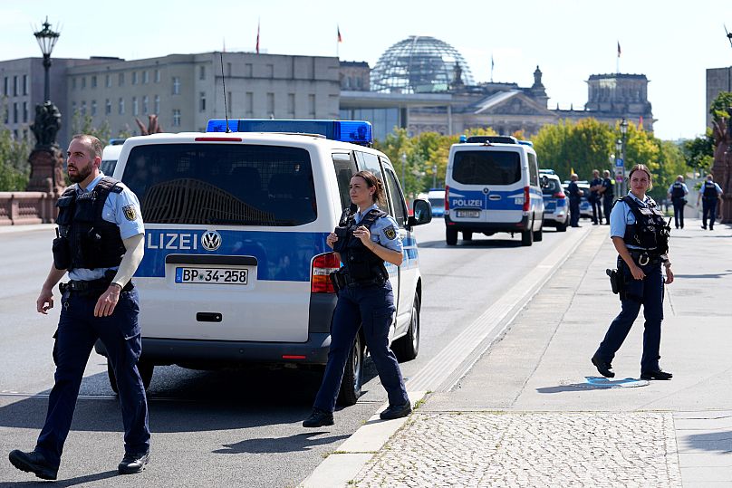 Police officers guard a bridge next to the chancellery in Berlin, 13 August, 2025