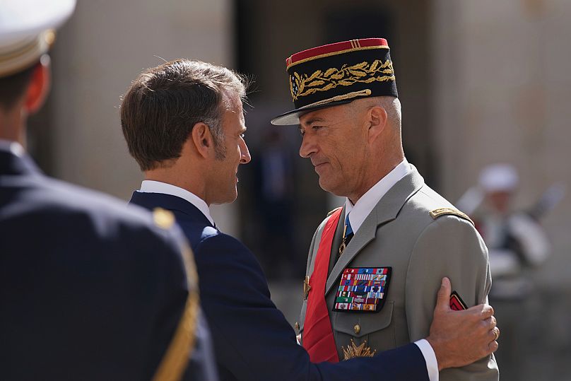 France's President Emmanuel Macron, left, honours outgoing Chief of Staff of the French Armed Forces Thierry Burkhard in Paris, 5 September, 2025
