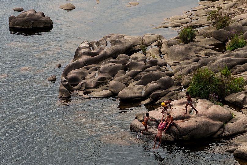Children cool off in the Mino River in Ourense, 30 August, 2024