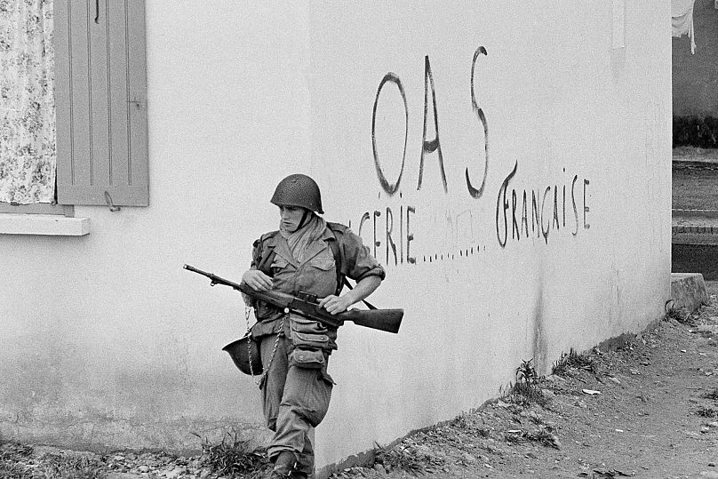 FILE - A soldier of the French army is shown in position at the corner of a building in the St. Eugene district of Oran in Algeria, 28 April 1962