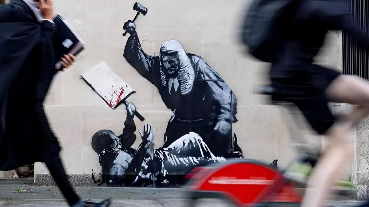 It's a cover-up: New Bansky artwork hidden by guards at London's Royal Courts of Justice