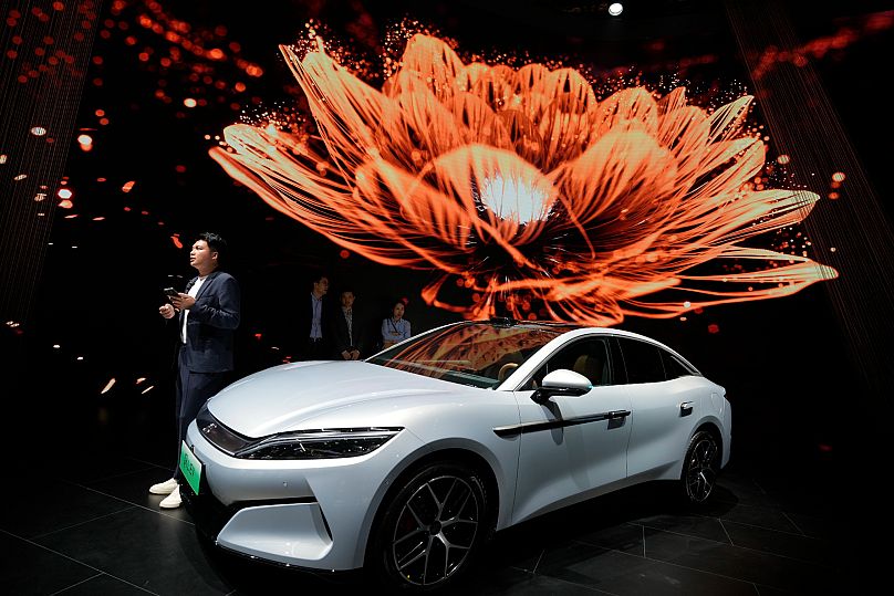 A man stands near the Han L EV model from BYD during the Shanghai auto show, 23 April, 2025