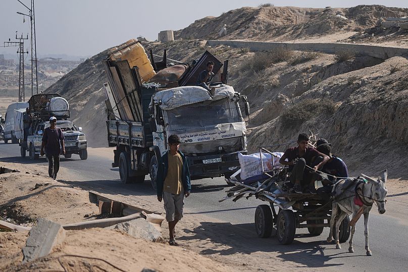 Displaced Palestinians fleeing northern Gaza carry their belongings along the coastal road toward southern Gaza, 9 September, 2025