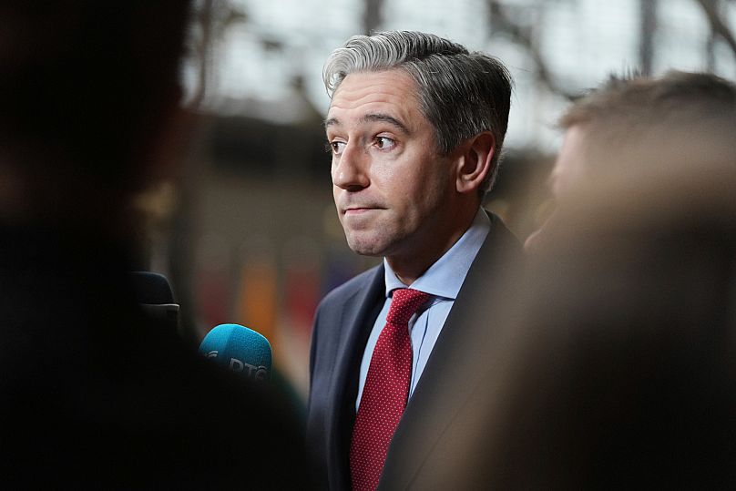 Ireland's Foreign Minister Simon Harris speaks with the media as he arrives for a meeting of EU foreign ministers at the European Council building in Brussels, 23 June, 2025