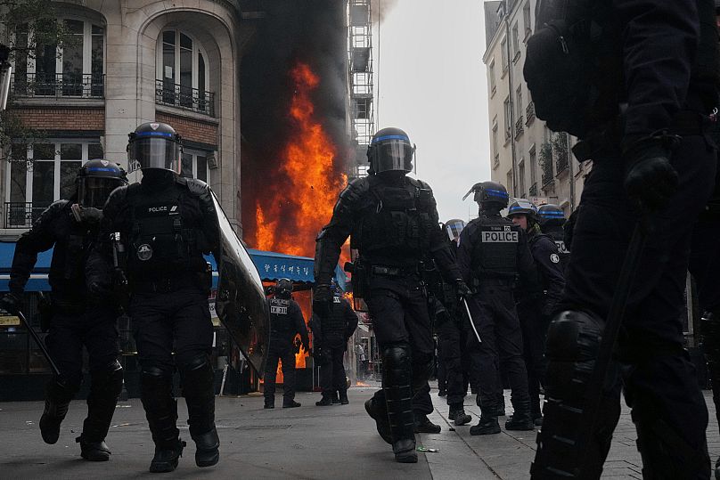 Riot police officers take position in front of a burning restaurant during the “Block Everything” protest movement in Paris, 10 September, 2025