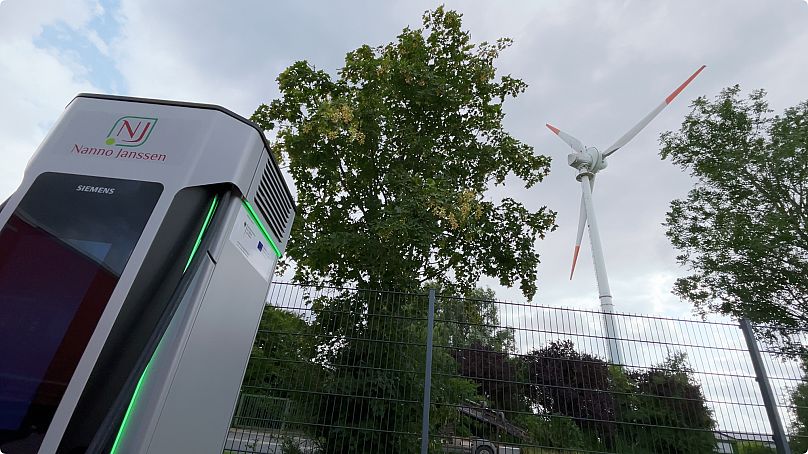 Hinter der Ladesäule dreht sich das firmeneigene Windrad.