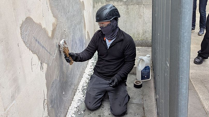 The Banksy artwork being scrubbed off