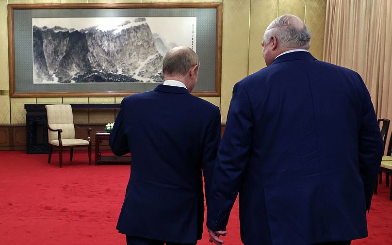 Russian President Vladimir Putin and Belarusian President Alexander Lukashenko walk during their meeting at Diaoyutai State Guesthouse in Beijing, 2 September 2025
