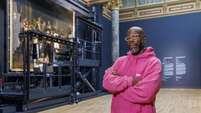 Director Steve McQueen in front of Rembrandt's The Night Watch, ahead of the Rijksmuseum screening of his 34-hour Occupied City documentary
