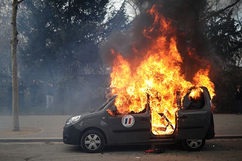 A burning command car belonging to France's anti-terror 'Vigipirate' squad, during a Yellow Vests demonstration in Paris, 9 February 2019