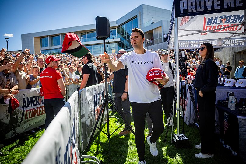 FILE: Charlie Kirk hands out hats before speaking at Utah Valley University in Orem, Utah, 10 September 2025